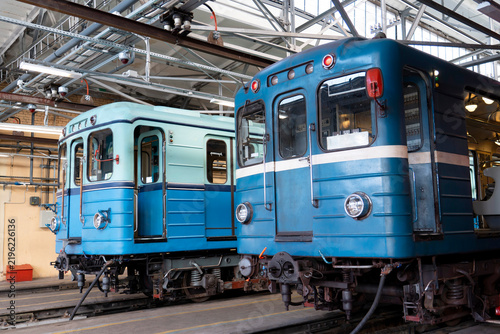 Photography Two classic electric rail carriages parked side by side under the metallic ceili