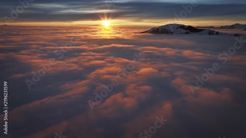 Real video of sea of clouds, flying above, gradually rising, heaven like atmosphere