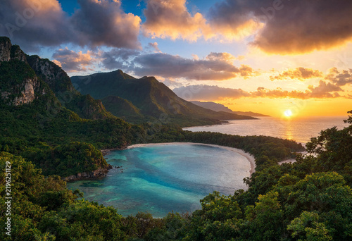 Hidden Tropical Cove Enclosed by Jungle Mountains at Sunset