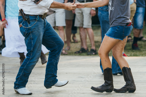 Couple Holding Hands While Line Dancing Two-Step Together