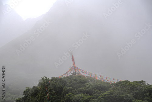 Dramatic Mountain Peaks in Dense Fog With Tibetan Prayer Flags in Abujicuo, China