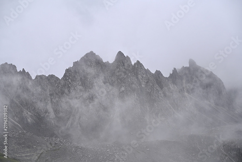 Majestic High-Altitude Peaks Emerging Through Heavy Mist Near Abujicuo in Shangri-La, Yunnan Province, China