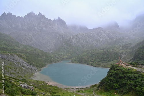 Scenic Landscape of Abujicuo Alpine Lake Under Cloudy Sky in Shangri-La, Yunnan, China