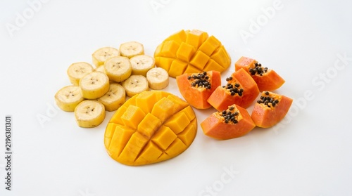 Tropical Fruit Medley: A vibrant assortment of ripe mango, papaya, and sliced bananas arranged invitingly, showcasing the fresh, exotic flavors of the tropics.