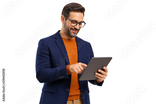 Man in glasses smiling while using digital tablet, navy blazer and orange sweater, isolated on transparent background. Technology, communication, business, professional lifestyle.