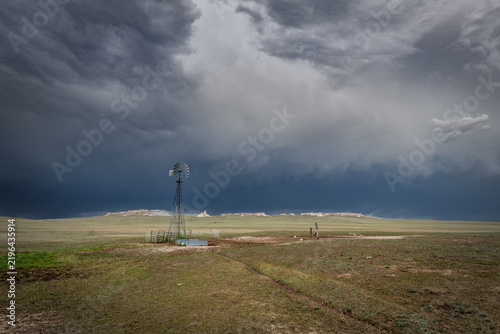 Rustic old farming windmill in stormy weather