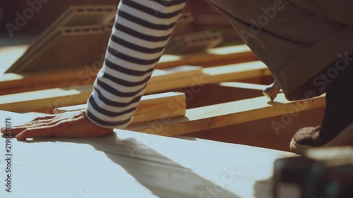 Installation of decking boards, floor installation, house construction