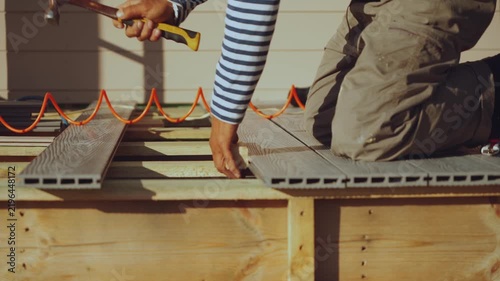 Installation of decking boards, floor installation, house construction