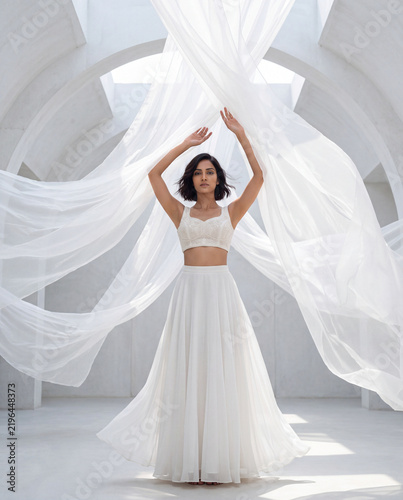 Indian Female Model Wearing White Bridal Inspired Outfit With Flowing Fabric generative ai