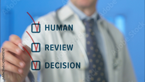 Doctor reviews virtual checklist on screen, highlighting human oversight, ethical decision making and accountability in ai driven healthcare for safe, trustworthy patient care and innovation