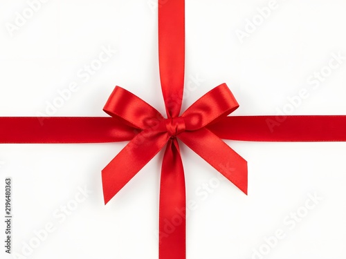 Red velvet ribbon bow tied in cross pattern on clean white background for packaging design