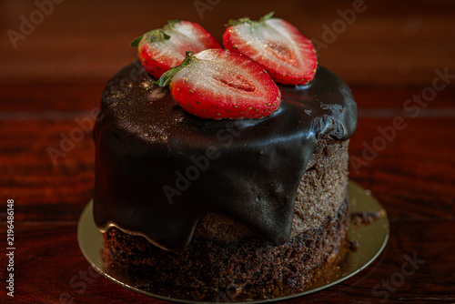 Chocolate strawberry fruit dark brown cake wooden table