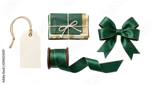 Gift wrapping set with green satin ribbon bow, spool of ribbon, and blank paper tag isolated on transparent background
