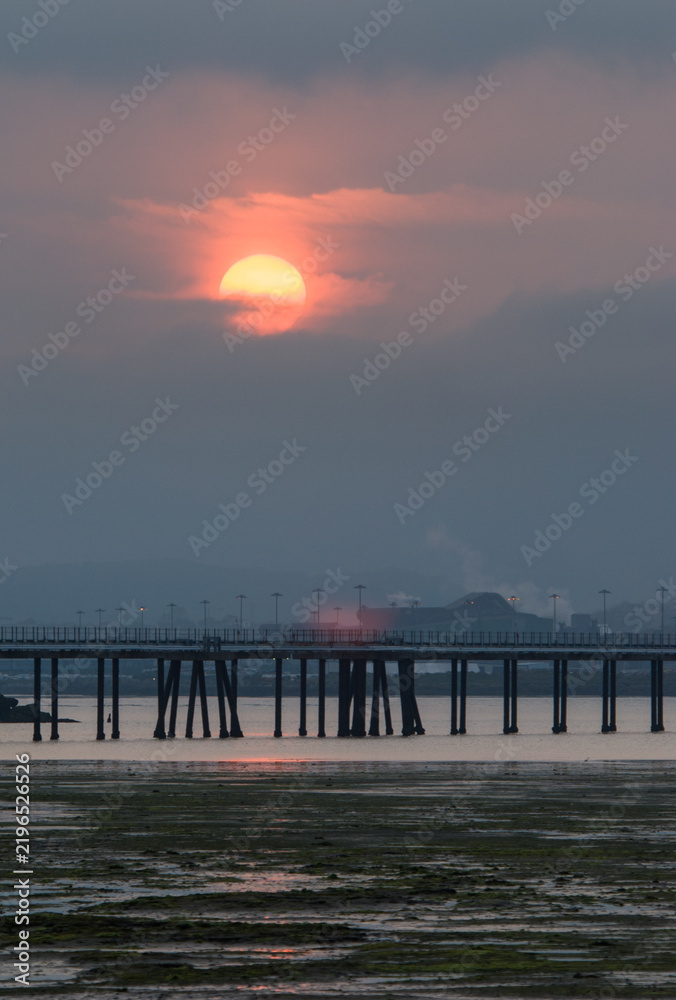 Obraz premium Sunset over Calatrava Pier and industrial waterfront in Santander Bay, Spain