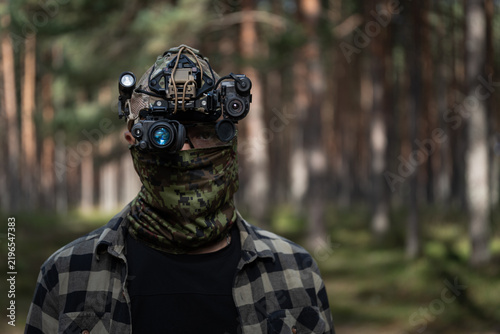 Konstfotografi Special forces operator in camouflage face mask wearing head mounted night visio