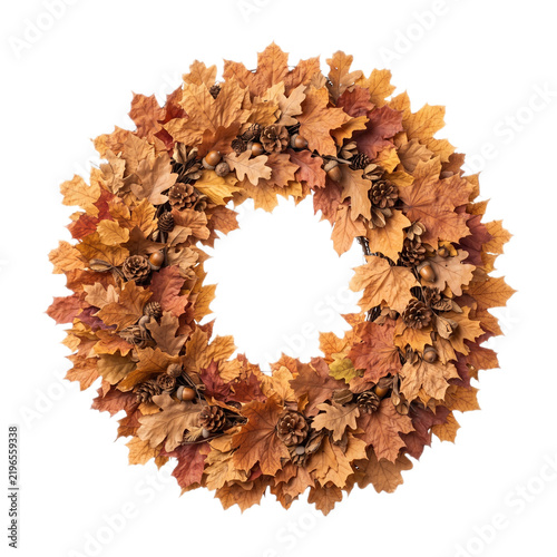 A festive autumn wreath made of dry maple leaves and pinecones isolated on white background with decorative circular wreath isolated against plain