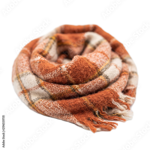 A rolled orange and white plaid wool scarf isolated on a clean white background surface with soft textured plaid orange cream colors colors coiled