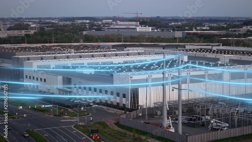Aerial data center view with glowing power lines showing energy grid. Concept of electricity demand for AI technology