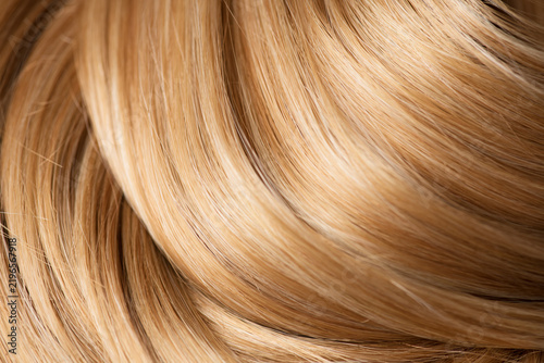 Blond hair curls background, lock of hair, healthy and beauty dyed hair backdrop design, salon, treatment, cure, dying concept. Close up, top view. 
