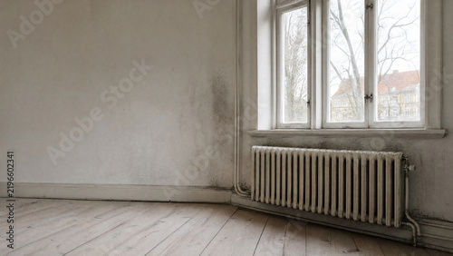 Cold wall behind an old European radiator