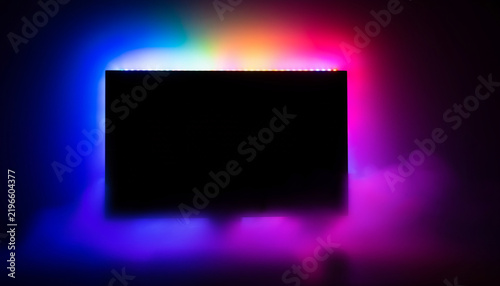 Blank Television Screen with Colorful RGB Backlight and Smoke Effect in Dark Room