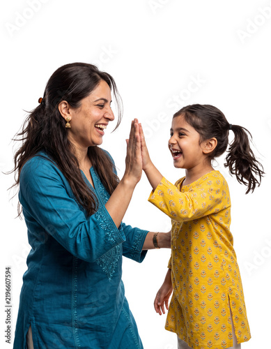 Mother and daughter high five with joyful smiles, isolated studio portrait with space for text