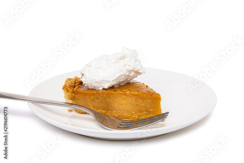 A Slice Of Pumpkin Pie with Whipped Topping On A Plate with Fork