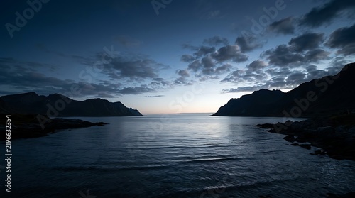 Dark sea and mountain silhouettes at twilight