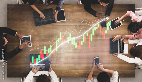 Принти на полотні A diverse team engages in financial data analysis, collaborating over laptops and tablets