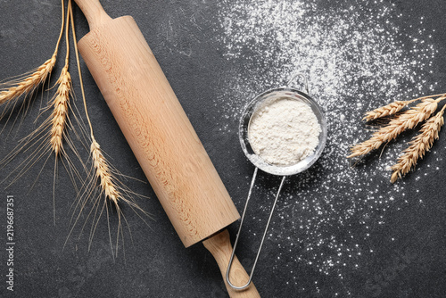 Fotografie Baking and culinary arts, wooden rolling pin with wheat stalks and flour sieve o