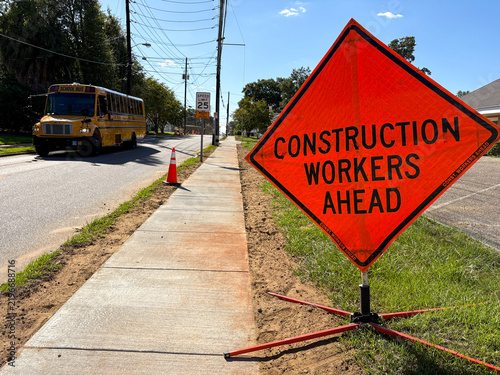 Road Construction Warning Sign Along Street with Safety Traffic Signage