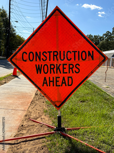 Road Construction Warning Sign Along Street with Safety Traffic Signage