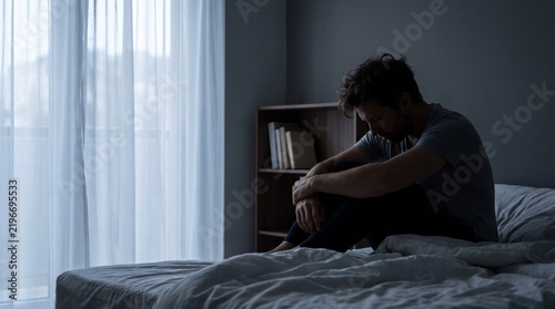 Emotional Wellness Awareness Image Showing Isolated Man Sitting Alone in Bedroom During Difficult Personal Experience