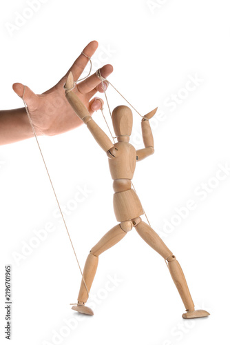 Принти на полотні Hand of puppeteer manipulating marionette on white background