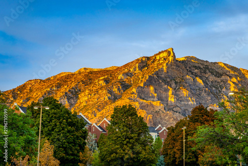 Golden hour sunlight illuminates Y Mountain above Brigham Young University