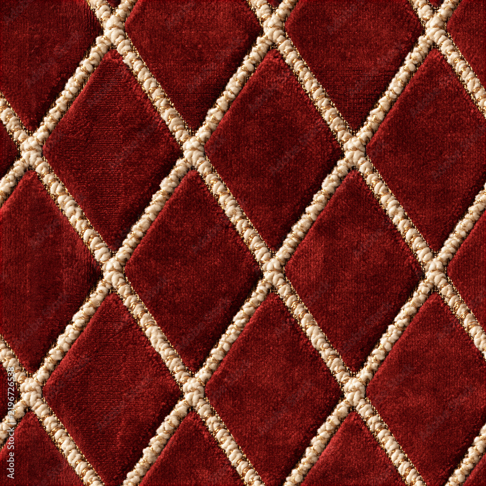Obraz premium Seamless pattern red velvet fabric forming a quilted diamond pattern with decorative gold and beige trim, creating a rich, opulent texture