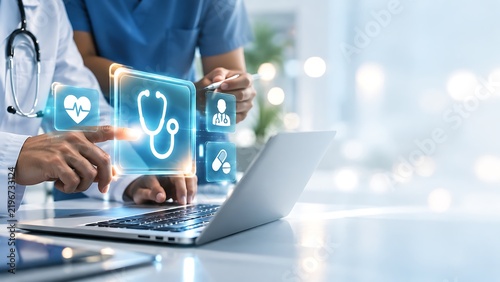 Medical professionals using laptop with futuristic digital icons for healthcare technology and telemedicine.