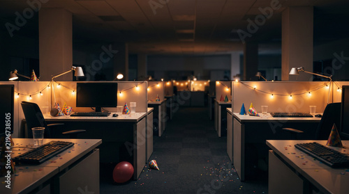 Dimly lit Empty office with party hats and string lights for a corporate holiday event