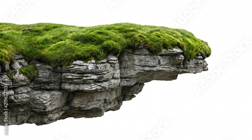 Rock cliff overhang on white background with green grass and moss covered limestone layers