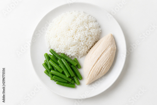Flavorless bland diet meal, plain white plate with steamed rice, boiled chicken breast and unsalted green beans