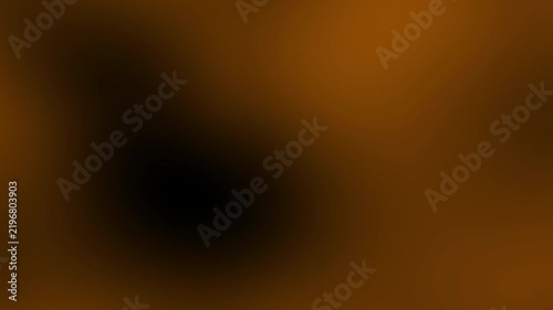 Blurred abstract image featuring a dark and orange gradient with soft transitions, creating a warm and mysterious atmosphere.