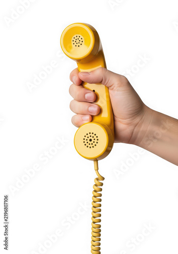 Hand holding retro style yellow telephone receiver isolated on transparent background