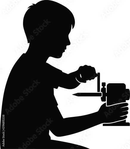 Silhouette of boy sharpening pencil with manual sharpener.