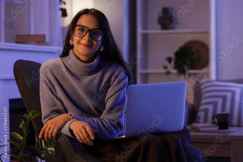 Remote work and work-life balance, young woman using a laptop in a cozy home ...