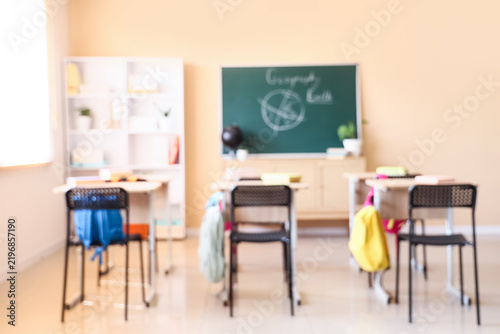 Education and school reopening, empty classroom with desks and chalkboard for...