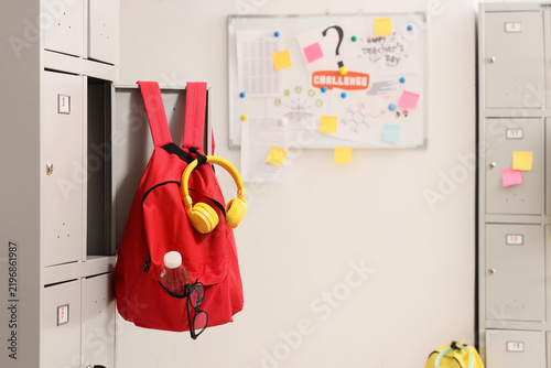 Back to school and education concept, red backpack with headphones and glasse...