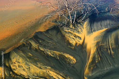 Aerial view of abstract mining pattern, nature pollution, colorful decanting lake