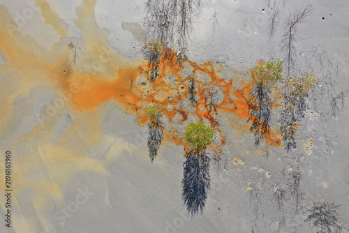 Aerial view of abstract mining pattern, nature pollution, colorful decanting lake