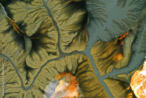 Aerial view of abstract mining pattern, nature pollution, colorful decanting lake