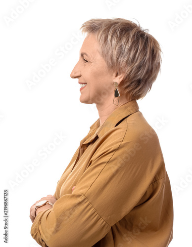 Blonde mature woman with short hair in beige shirt on white background